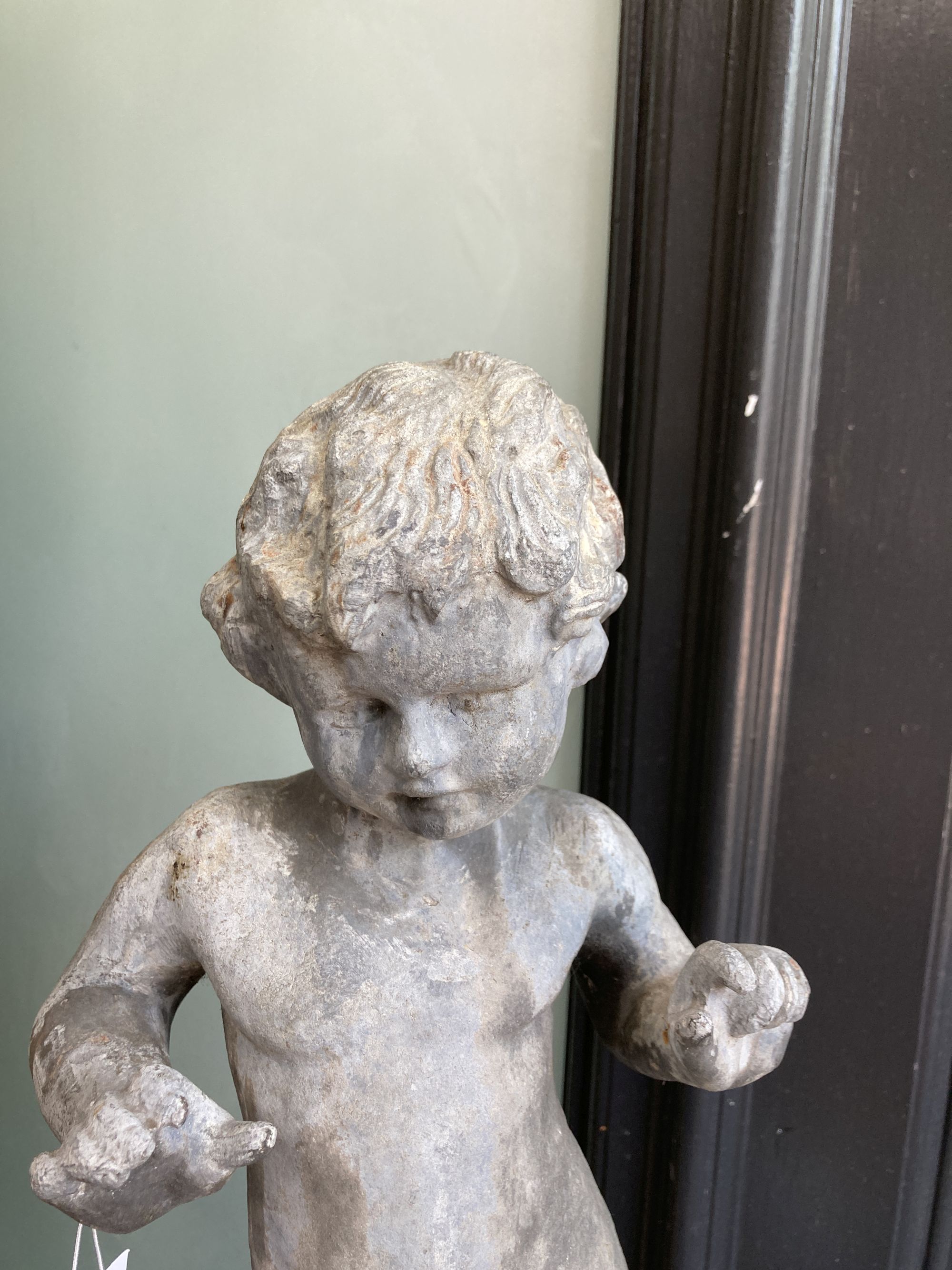 A Victorian lead garden ornament of a putto on orb, height 80cm